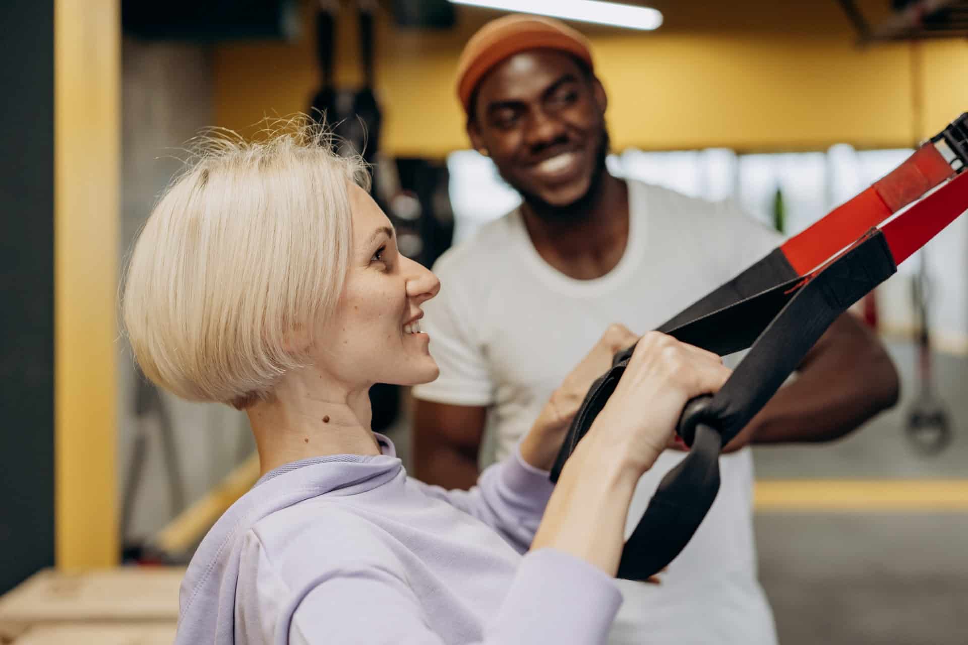 Young woman exercising with suspension trainer at Cendant Stem Cell Center, promoting regenerative health.